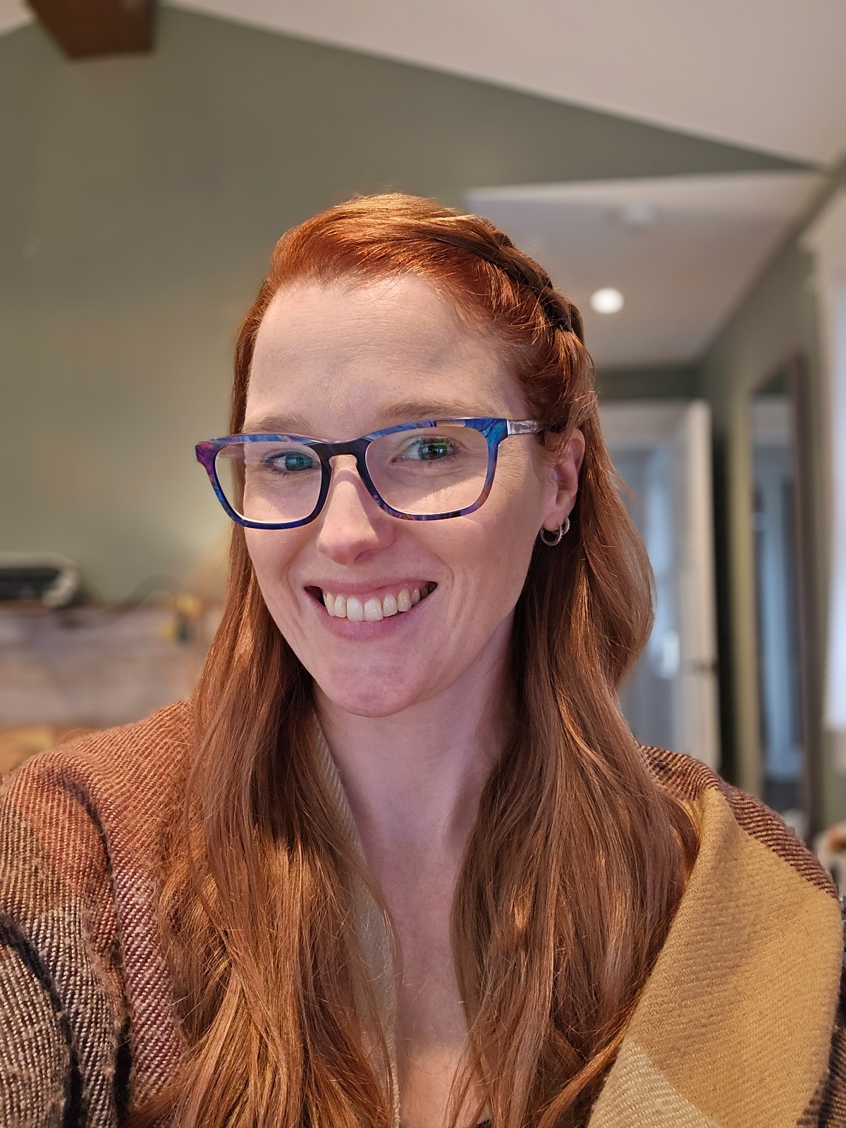Megan Olynik smiling in a softly lit room